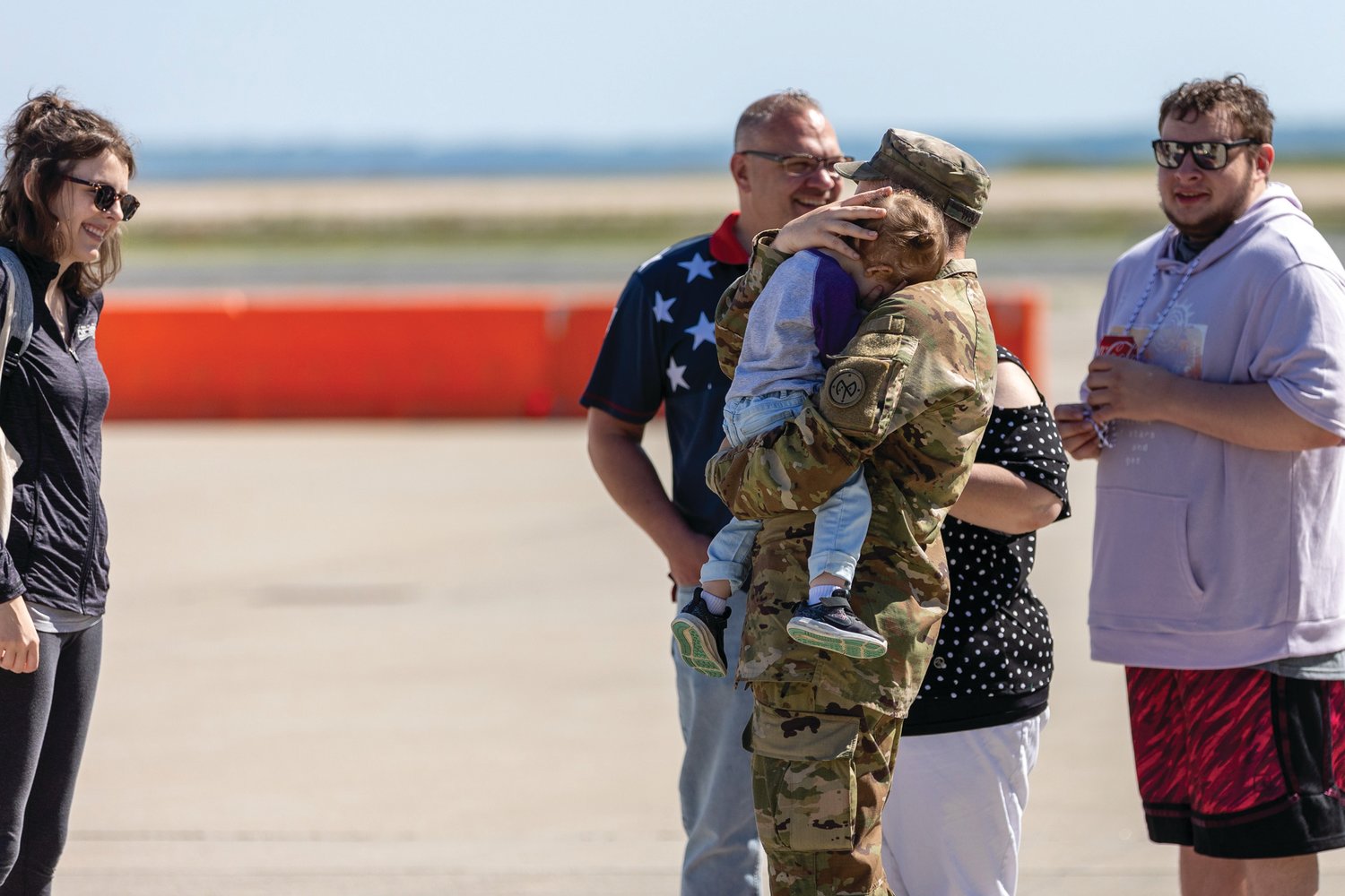 GOODBYES: Specialist Connor Wood from Killingly, Connecticut, says goodbye before deployment. The Rhode Island National Guard hosted a departure ceremony for Alpha Company, 1-182nd Infantry Battalion, nicknamed “Attack” Company, at the Army Aviation Support Facility on Quonset Air National Guard Base on Memorial Day.